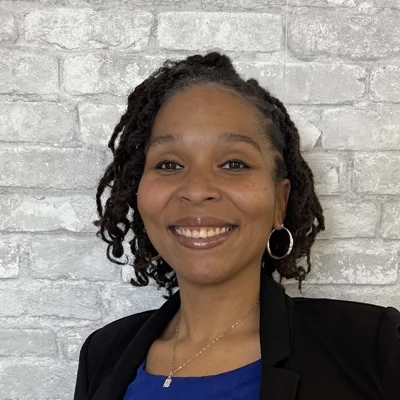 Trey Jernigan-Taylor smiling in front of a brick wall.